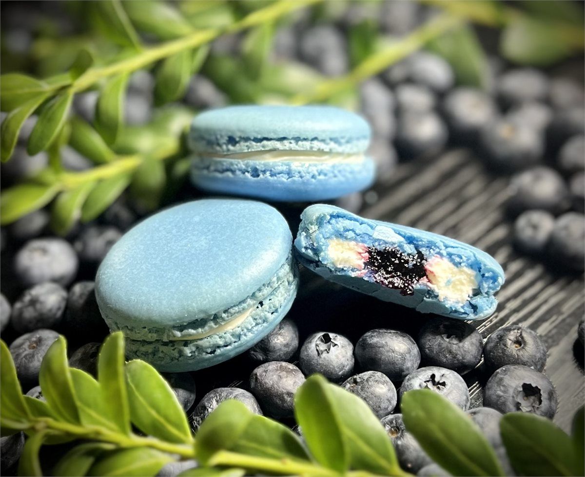 Blueberry macarons with blueberries and a visible fruit center