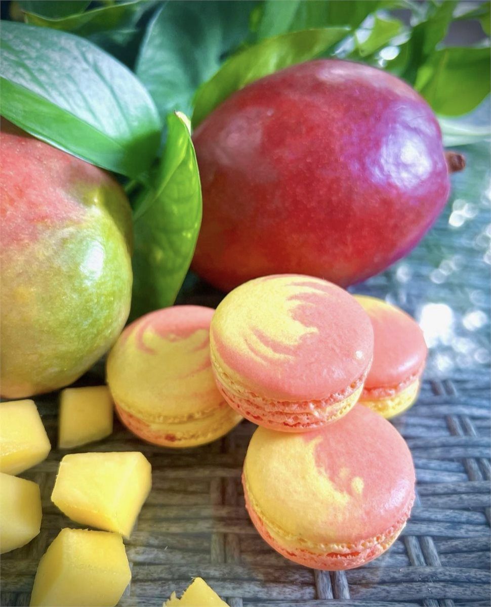 Pink and yellow mango macarons with fresh mango