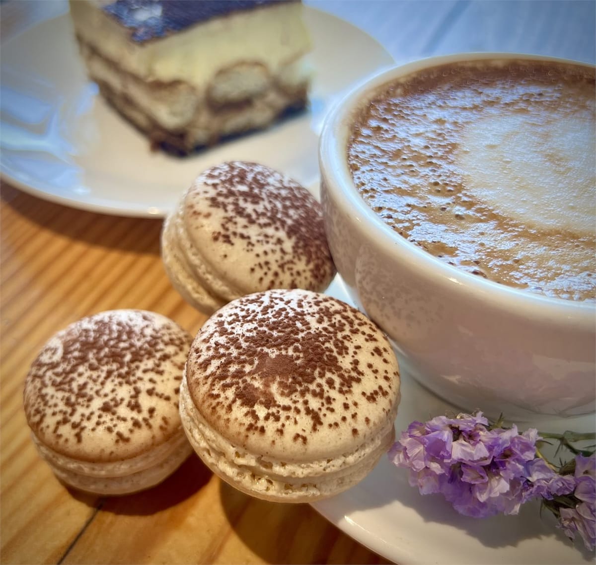 Zhenya finishing a tray of macarons in the kitchen